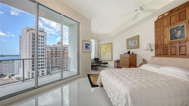 bedroom with access to exterior, tile patterned floors, a water view, and a ceiling fan