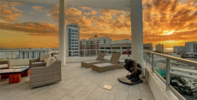 view of patio / terrace featuring a view of city and a balcony