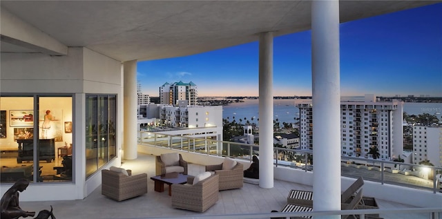 balcony with a view of city and a water view