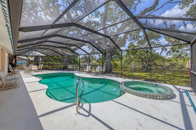 view of pool featuring a patio, a pool with connected hot tub, and glass enclosure