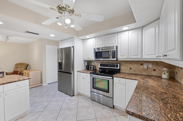 kitchen featuring appliances with stainless steel finishes, decorative backsplash, a ceiling fan, white cabinetry, and recessed lighting