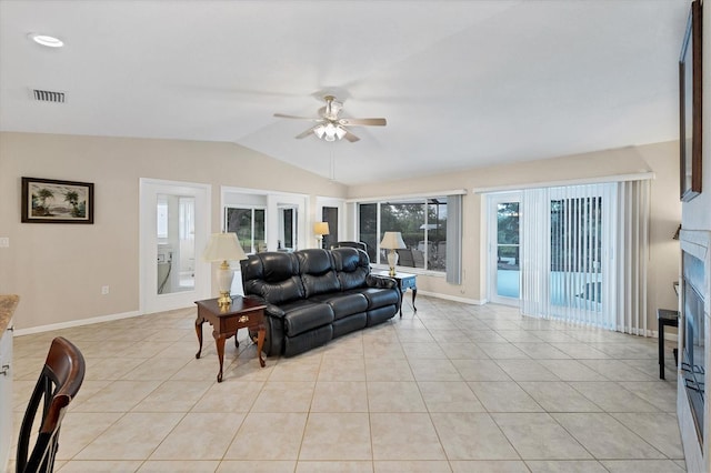 living area with a ceiling fan, lofted ceiling, light tile patterned floors, and baseboards