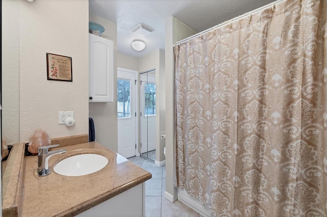 bathroom featuring tile patterned flooring, toilet, vanity, and a shower with curtain