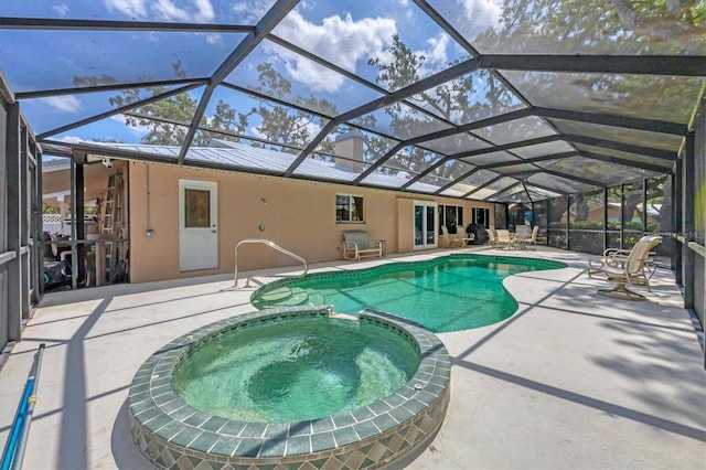 view of pool with a patio, a pool with connected hot tub, and a lanai