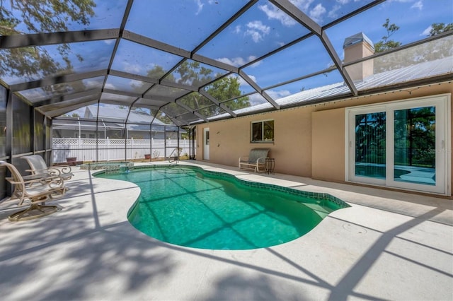 view of swimming pool featuring a patio area and a lanai