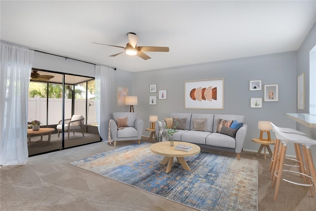 living room with a ceiling fan and carpet flooring