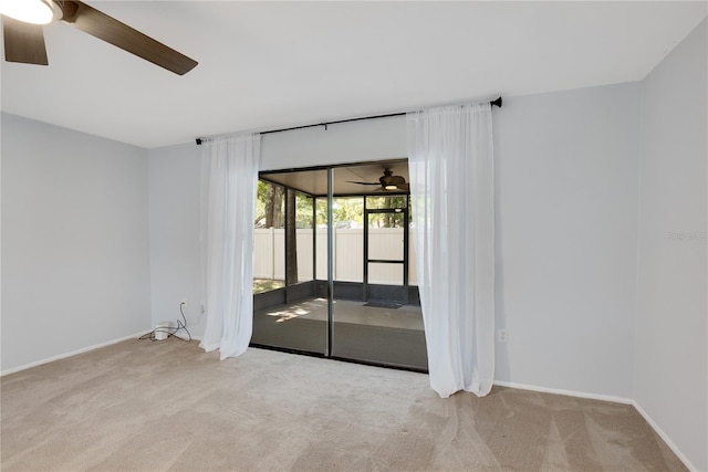unfurnished room with baseboards, a ceiling fan, and carpet flooring