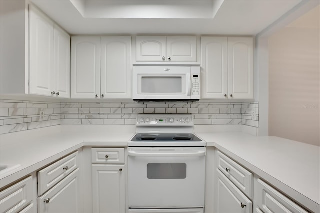 kitchen with decorative backsplash, white cabinets, white appliances, and light countertops