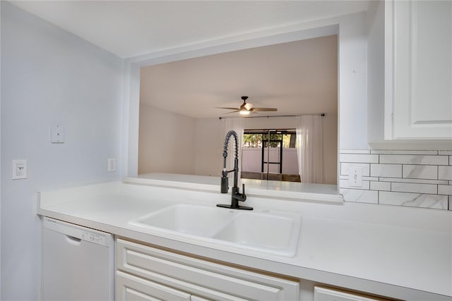 kitchen featuring white dishwasher, a sink, light countertops, a ceiling fan, and white cabinetry