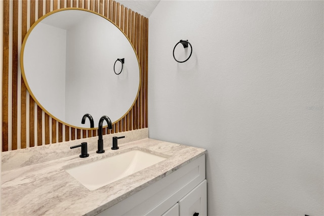 bathroom featuring vanity and wallpapered walls