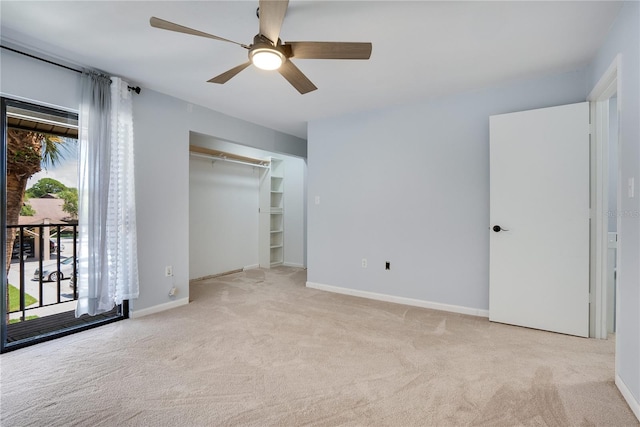 unfurnished bedroom featuring carpet flooring, a ceiling fan, baseboards, and multiple windows