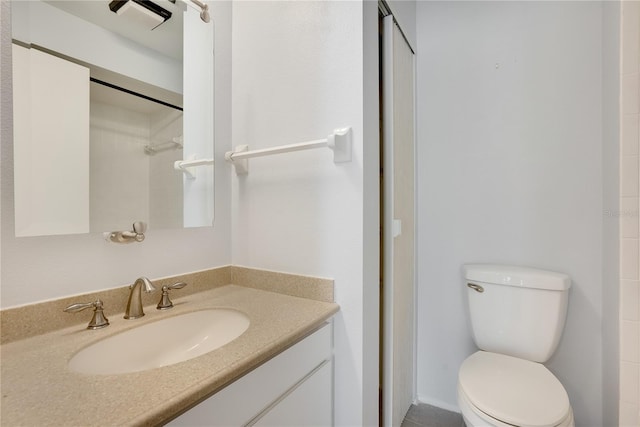 full bath featuring toilet, walk in shower, and vanity