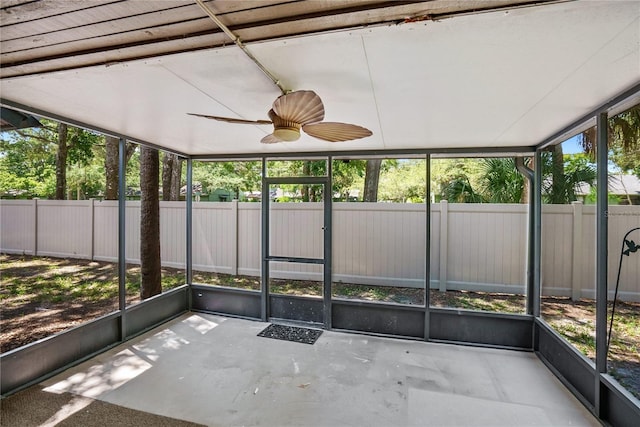 unfurnished sunroom with ceiling fan