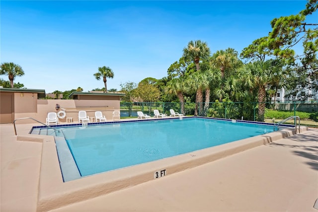 community pool featuring a patio area and fence