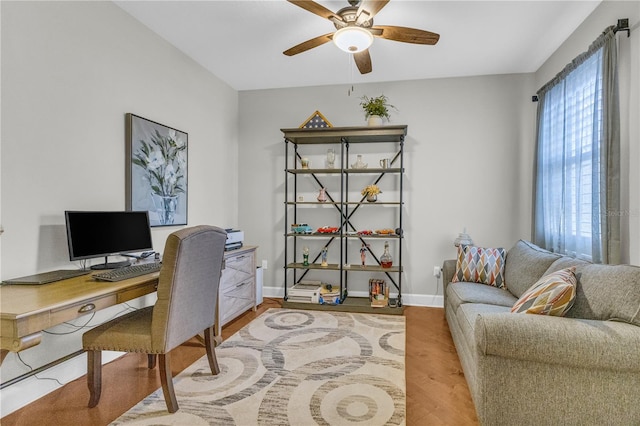 office featuring baseboards, ceiling fan, and wood finished floors