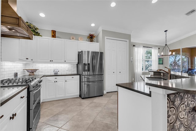 kitchen with dark countertops, ornamental molding, stainless steel appliances, and visible vents