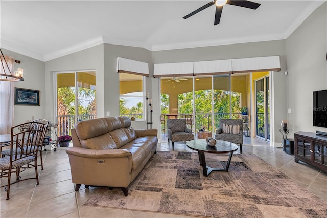 living area with plenty of natural light, ornamental molding, ceiling fan, and vaulted ceiling