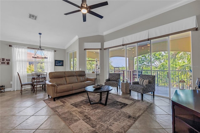 living room featuring visible vents, ornamental molding, plenty of natural light, ceiling fan with notable chandelier, and vaulted ceiling