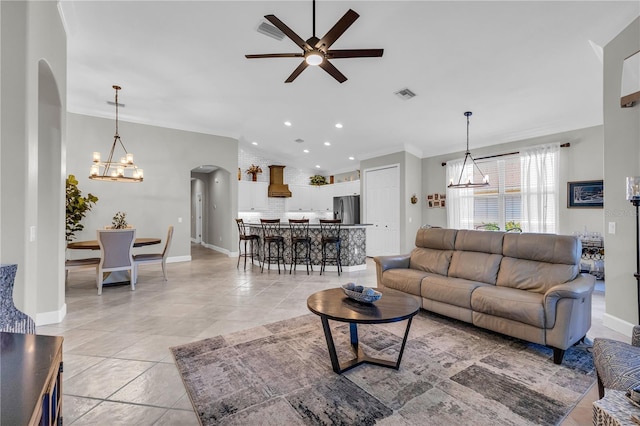 living room featuring visible vents, lofted ceiling, recessed lighting, arched walkways, and ceiling fan with notable chandelier