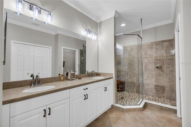 full bathroom with a sink, tile patterned flooring, crown molding, and a shower stall