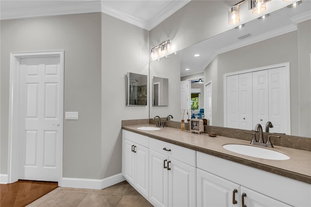 full bathroom with a sink, tile patterned flooring, ornamental molding, and double vanity