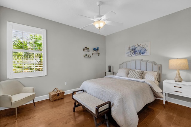 bedroom with baseboards, ceiling fan, and wood finished floors