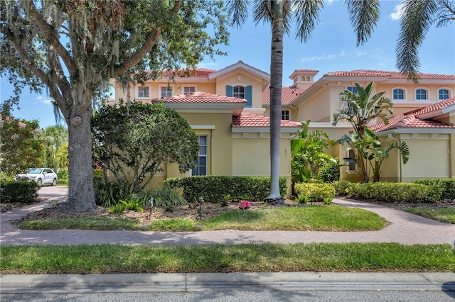 mediterranean / spanish-style home featuring stucco siding and a tile roof