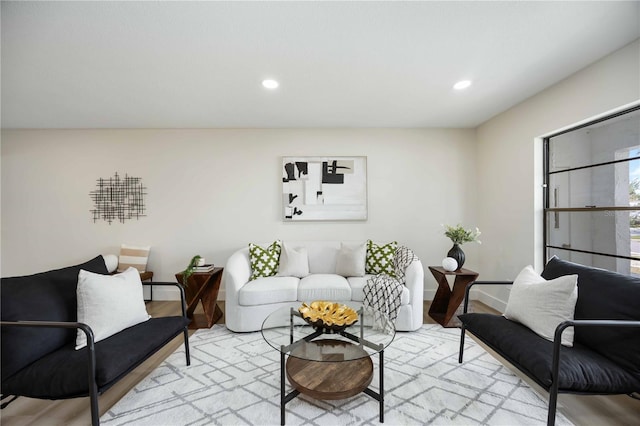 living area with recessed lighting, baseboards, and light wood-style floors