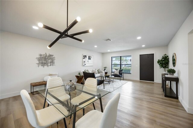dining space featuring baseboards, visible vents, and light wood-style flooring