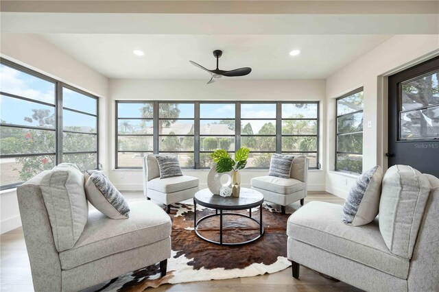 sunroom / solarium featuring recessed lighting, baseboards, and wood finished floors