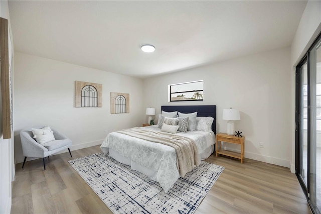 bedroom with baseboards and light wood-type flooring