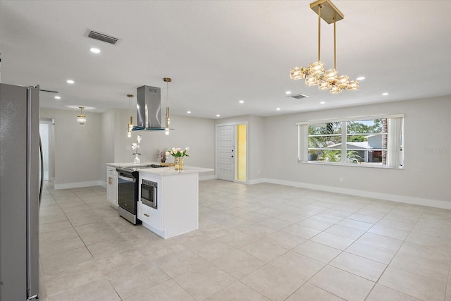 kitchen featuring visible vents, island range hood, light countertops, freestanding refrigerator, and open floor plan