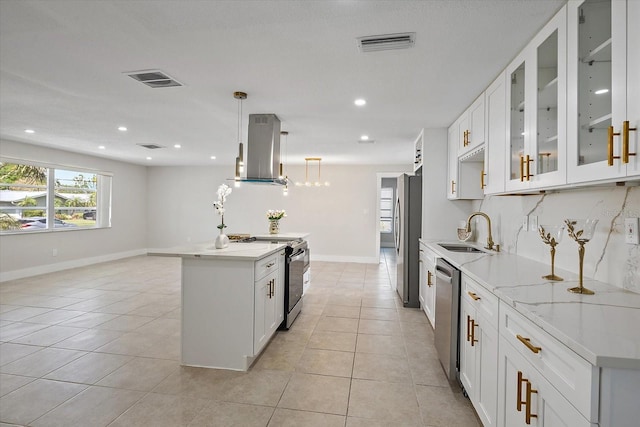 kitchen featuring a sink, stainless steel appliances, island range hood, light tile patterned floors, and a kitchen island