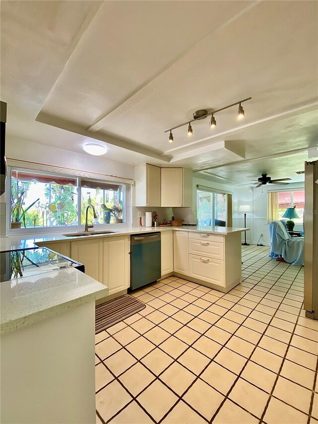 kitchen featuring white cabinets, light tile patterned flooring, a sink, a peninsula, and dishwashing machine