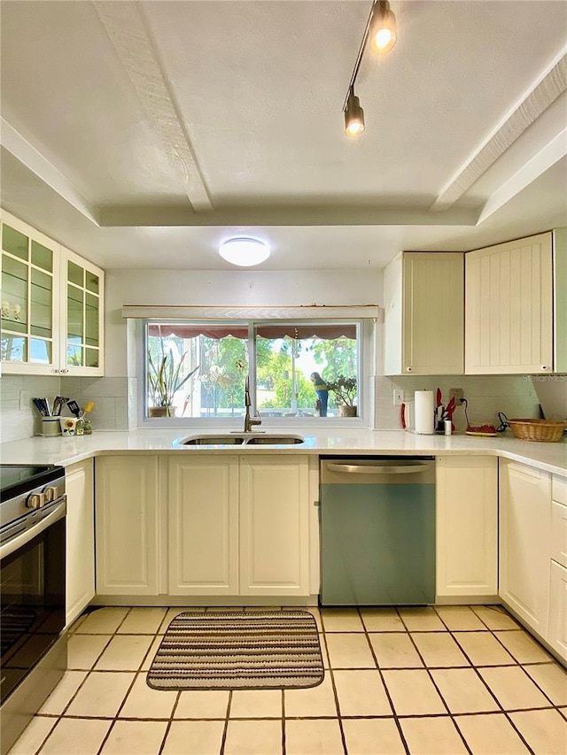 kitchen featuring a sink, tasteful backsplash, a wealth of natural light, and stainless steel appliances