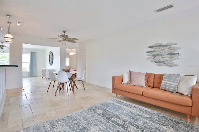 10108 Kingfisher Rd E, Bradenton, FL 34209 - living area featuring stone tile floors, baseboards, ceiling fan, and ornamental molding