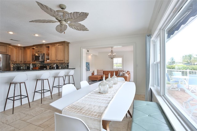10108 Kingfisher Rd E, Bradenton, FL 34209 - dining room featuring recessed lighting, a chandelier, a ceiling fan, and stone tile floors