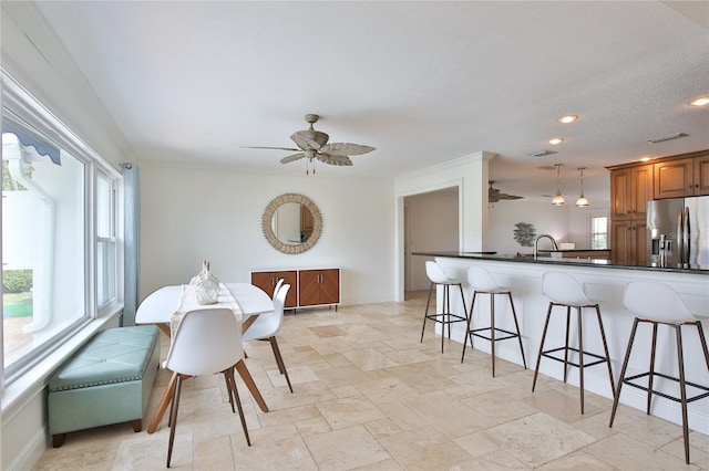 10108 Kingfisher Rd E, Bradenton, FL 34209 - dining area with a ceiling fan, baseboards, recessed lighting, and light stone finish floors