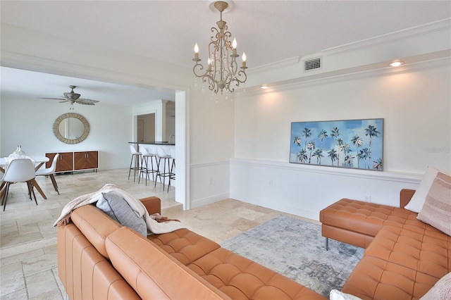 10108 Kingfisher Rd E, Bradenton, FL 34209 - living room featuring a chandelier, ornamental molding, stone finish floors, and ceiling fan