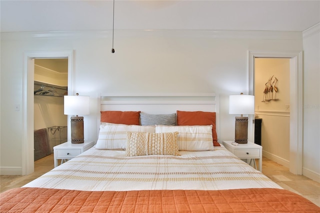 10108 Kingfisher Rd E, Bradenton, FL 34209 - bedroom featuring crown molding, a spacious closet, and baseboards