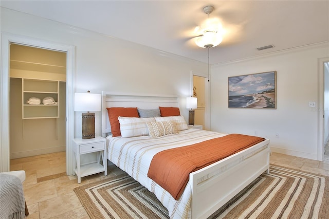 10108 Kingfisher Rd E, Bradenton, FL 34209 - bedroom featuring ornamental molding, a spacious closet, and baseboards