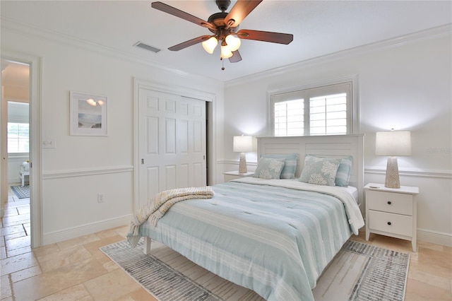 10108 Kingfisher Rd E, Bradenton, FL 34209 - bedroom featuring ornamental molding, a closet, ceiling fan, stone tile floors, and baseboards