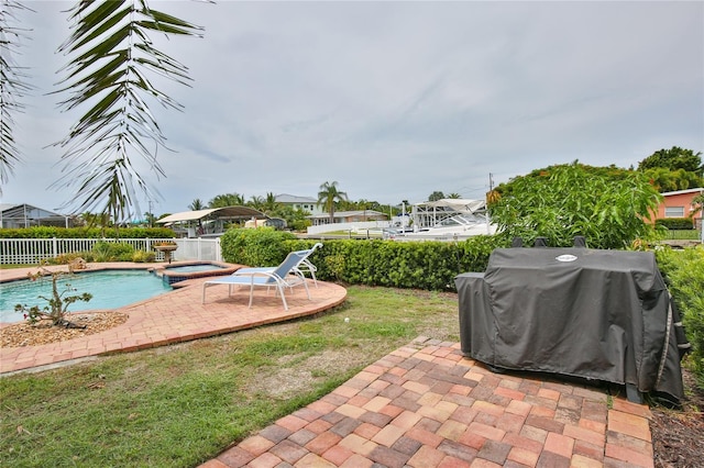 10108 Kingfisher Rd E, Bradenton, FL 34209 - view of patio with grilling area and a pool with connected hot tub