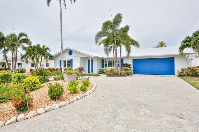 10108 Kingfisher Rd E, Bradenton, FL 34209 - ranch-style house with curved driveway, stucco siding, and an attached garage