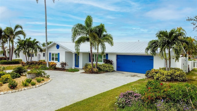 10108 Kingfisher Rd E, Bradenton, FL 34209 - ranch-style house featuring stucco siding, concrete driveway, an attached garage, and metal roof