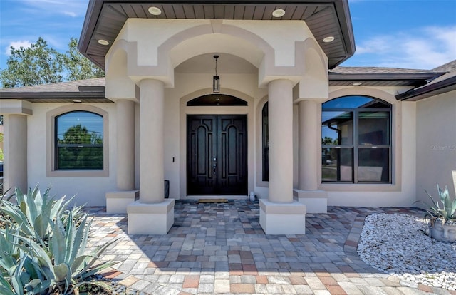8123 Wawana Rd, North Port, FL 34287 - view of exterior entry featuring roof with shingles and stucco siding