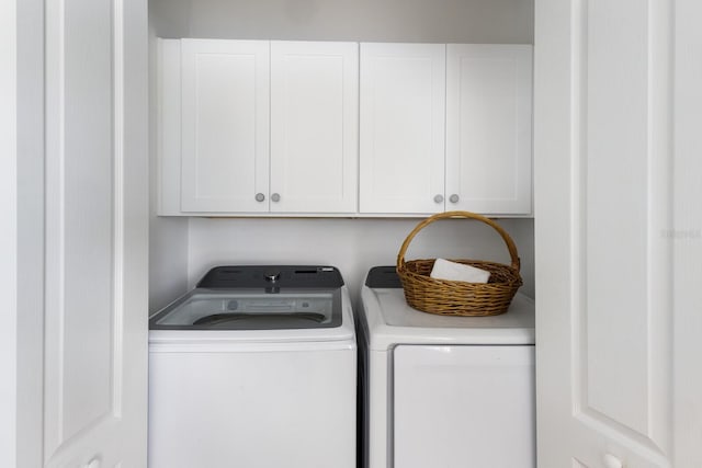washroom with cabinet space and independent washer and dryer