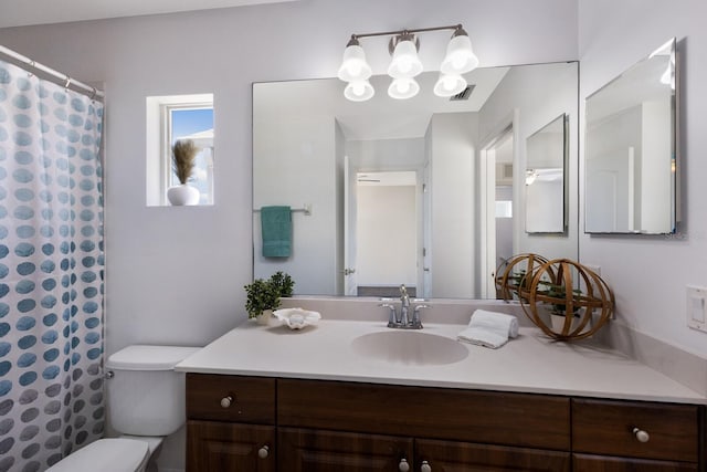 full bath featuring toilet, visible vents, curtained shower, and vanity