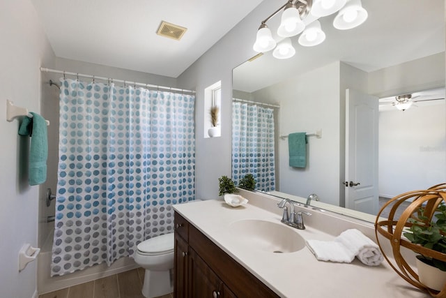 bathroom with vanity, toilet, a shower with shower curtain, wood finished floors, and visible vents