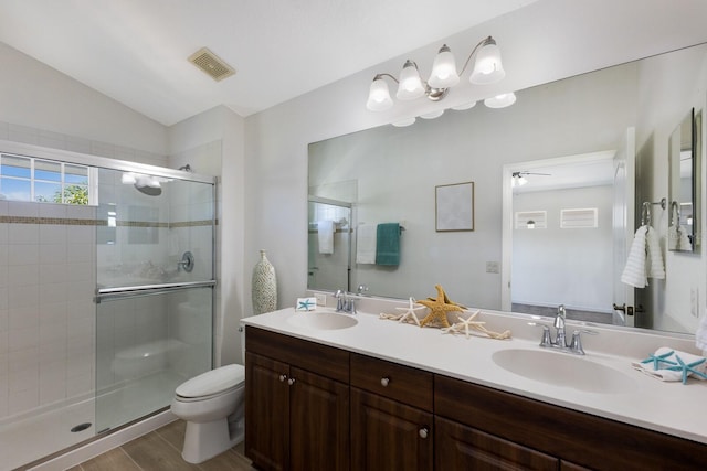 full bath with visible vents, a sink, lofted ceiling, and a stall shower